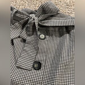 Black and white checkered skirt; bow belt; faux buttons